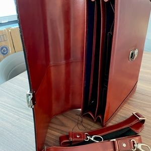 Men’s’ briefcase, brown new with tags. Has a long strap and organiser
